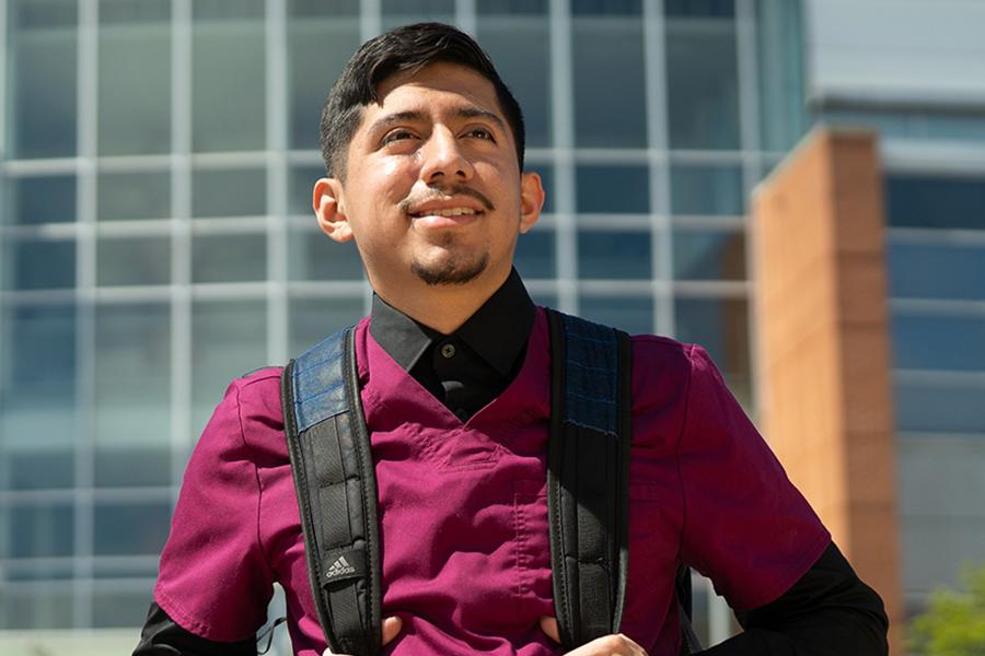 Recent grad at the College of Health and Human Services building.