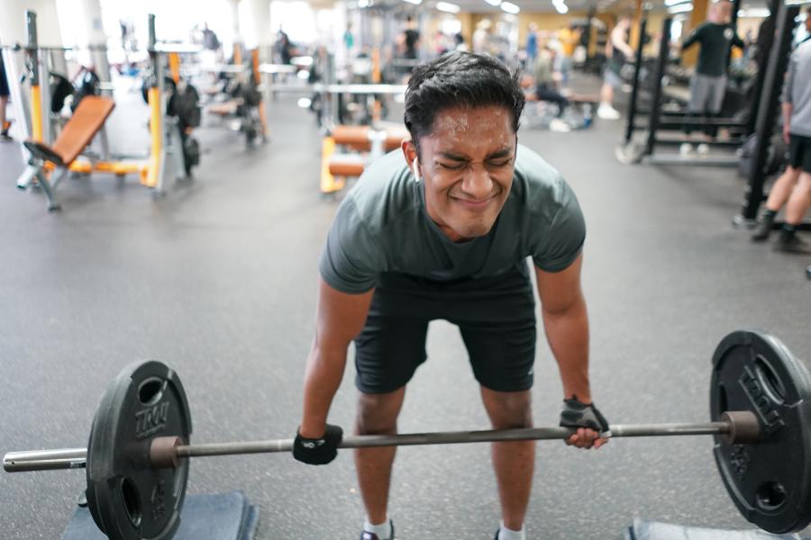 Student at the Rec Center lifting weights.