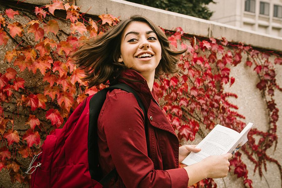 Student on main campus, fall colors.