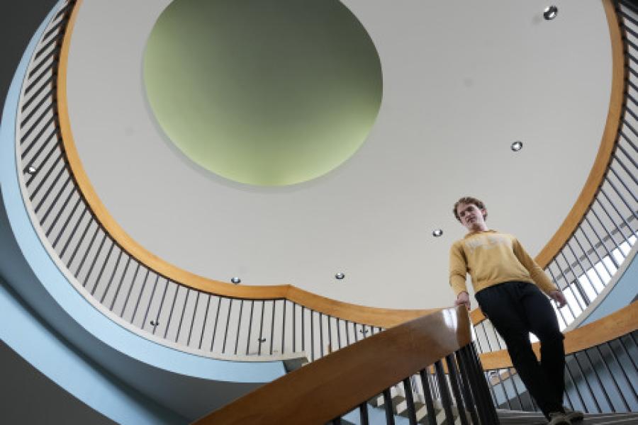 A student decending staircase at Faunce Student Services office.